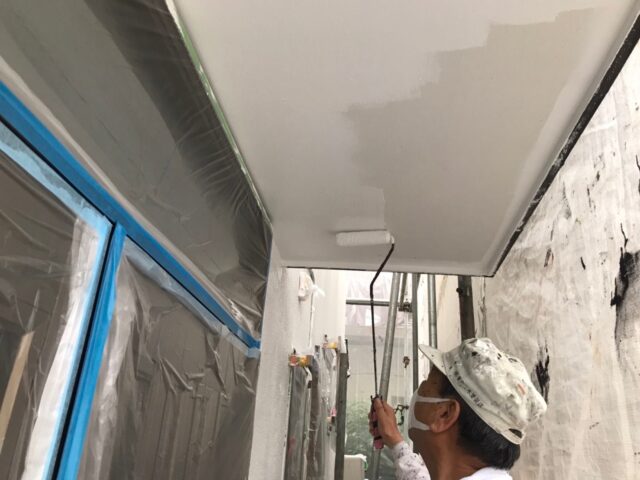 ローラーで白く塗装される三鷹市の住宅の軒天井