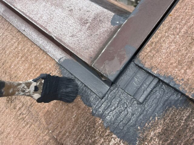 ハケで塗装される三鷹市の住宅の屋根